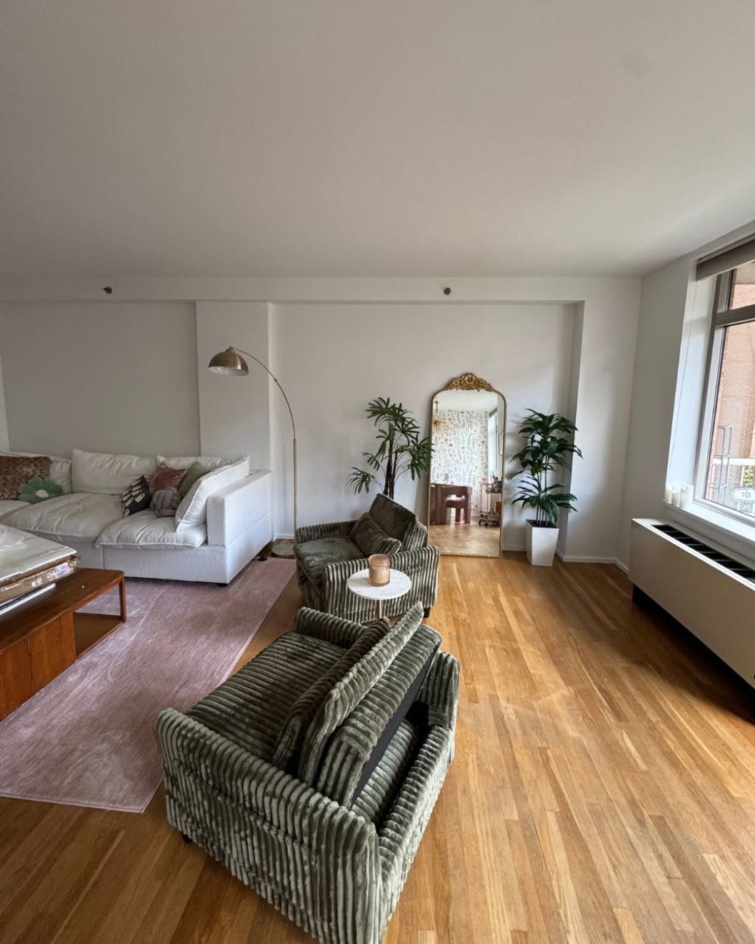 Living room with warm hardwood floors installed by Sulca's Carpets