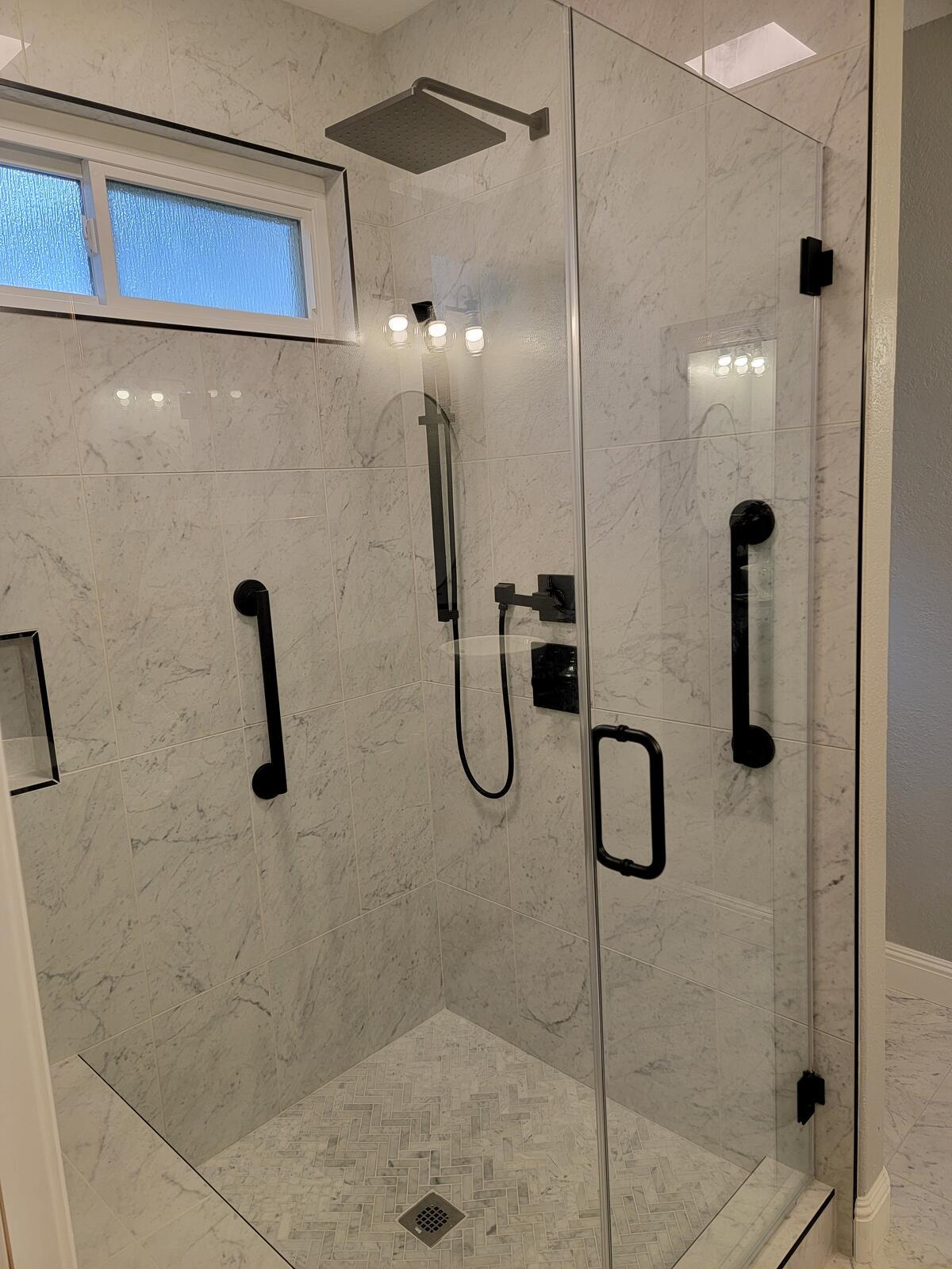 Bathroom remodel with walk-in shower and marble tile