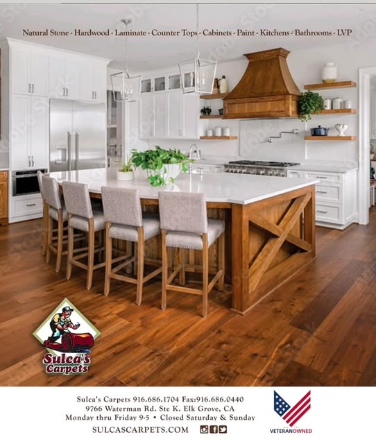 Kitchen remodel with large island and hardwood floors by Sulca's Carpets